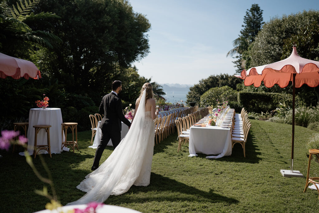 Married couple have a relaxed first look with their outdoor reception space on the back lawn of Lindesay House, captured by wedding photographer Scott Surplice